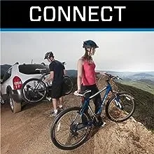 Woman and man unloading bikes from vehicle atop a hill